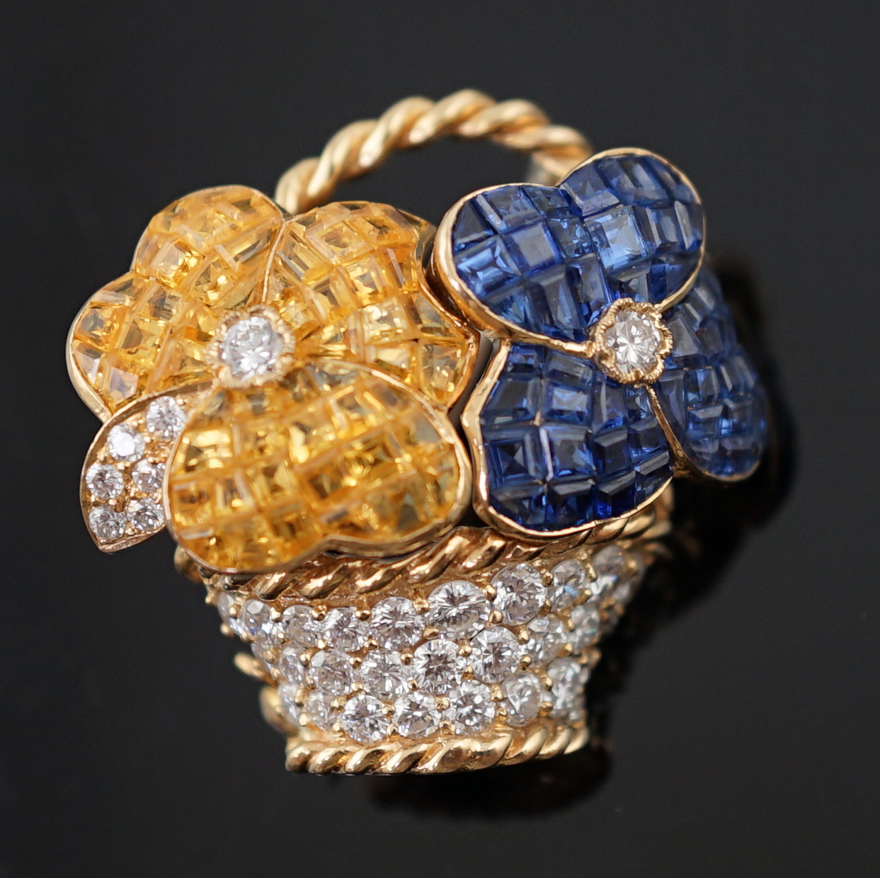 A Tiffany & Co 18k gold, two colour sapphire and diamond cluster set brooch, modelled as a basket with two flower heads